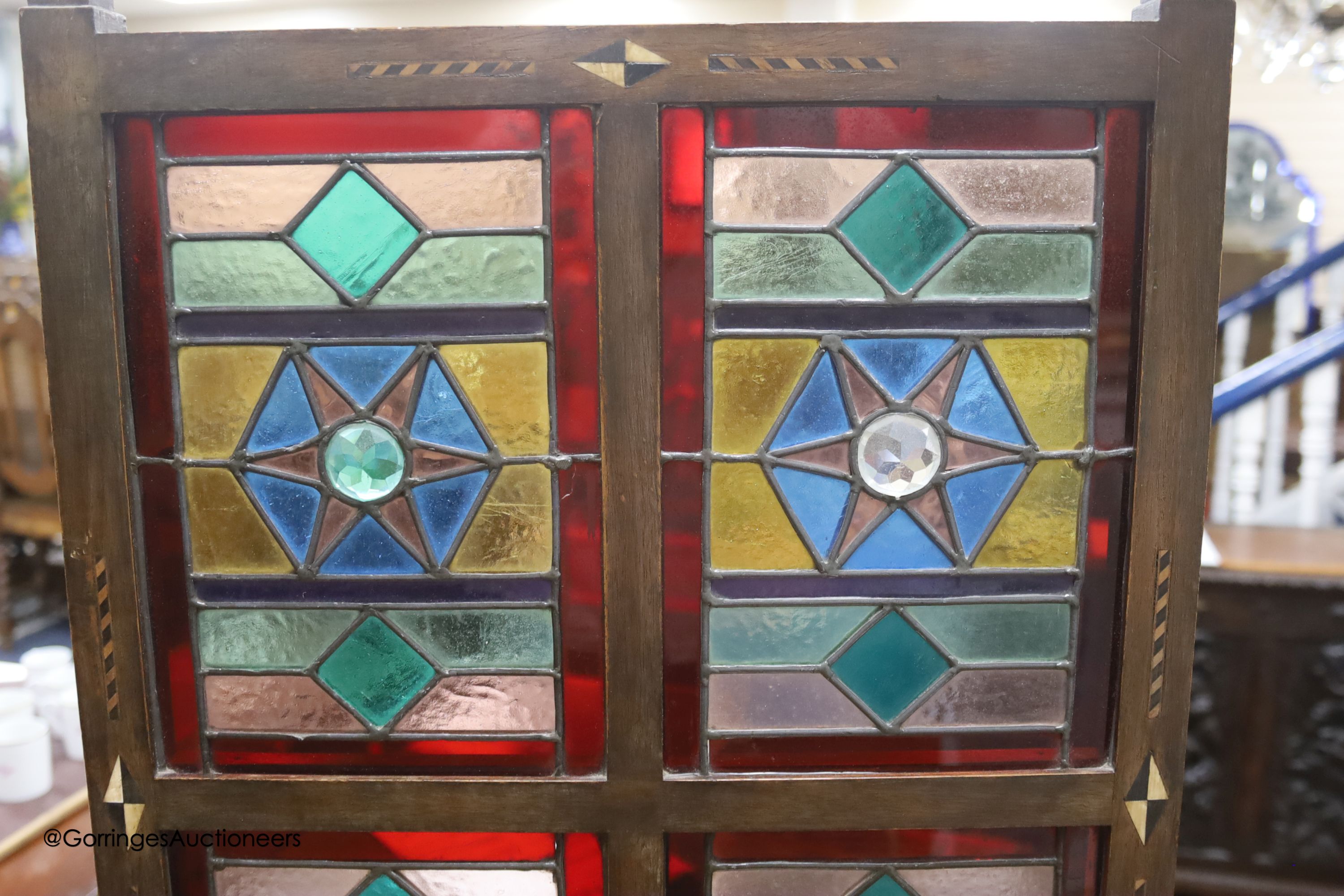 An Edwardian Liberty & Co. stained glass and beech leaded glass room screen, width 43cm, height 67cm